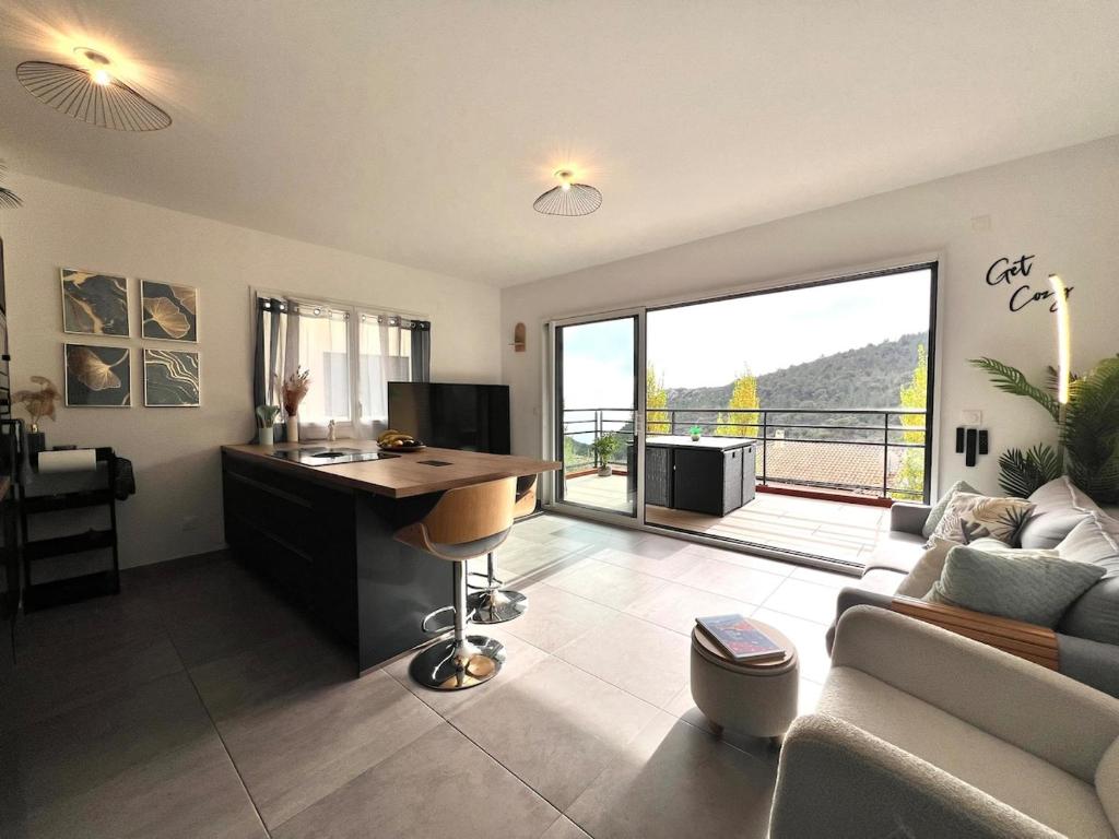 a living room with a desk and a couch at Modern Luxury - Sea View over Èze Village in Èze