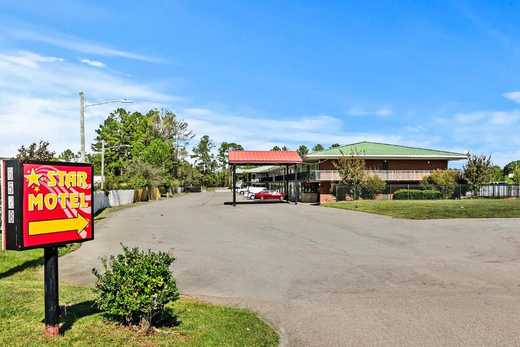 a store with a sign in front of a road at Hotel O Star Motel Hattiesburg HWY 49 in Hattiesburg