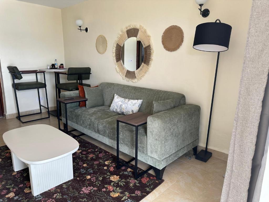 a living room with a couch and a table at Lakeview Apartments - The Nest in Mbita