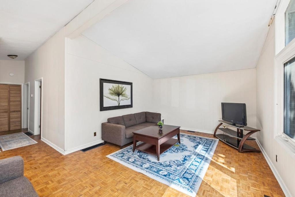 a living room with a couch and a tv at 4 Bedroom full house with 4 car parking in Kingston