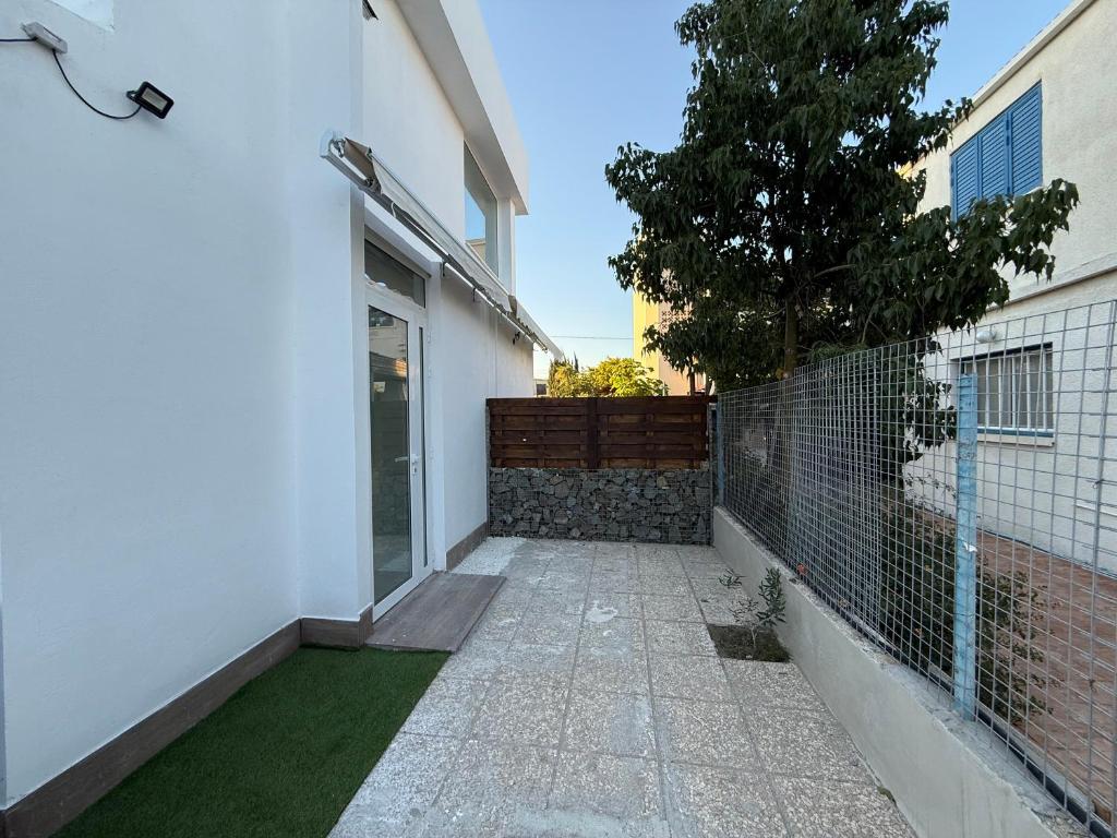 a walkway leading to a house with a fence at Onar Exclusive Studio Suite in Voroklini