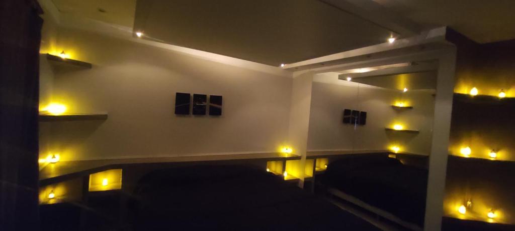 a room with yellow lights on the wall at RelaxMza in Mendoza