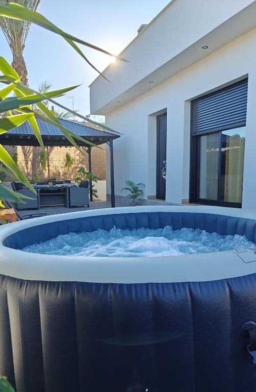 a jacuzzi tub in the backyard of a house at Villa romántica en Murcia con jacuzzi privado in Los López