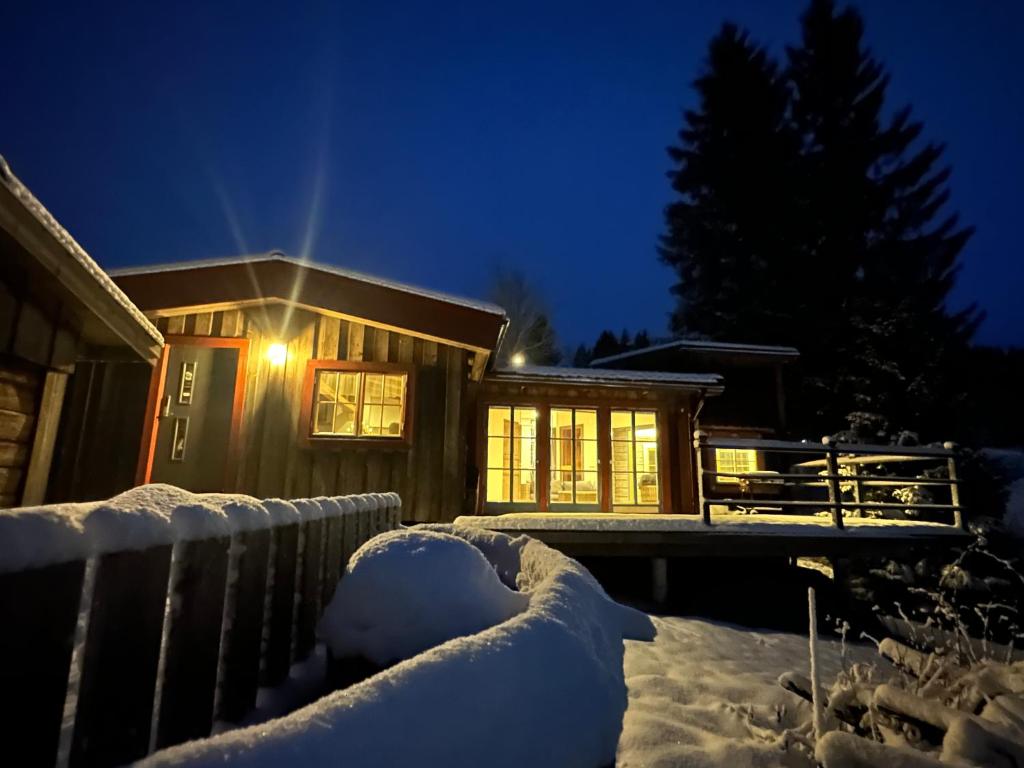 a house is covered in snow at night at Cozy cabin with an amazing view in Åre