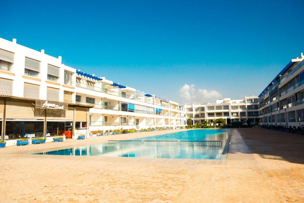a swimming pool in the middle of a building at Beachfront Apt in Aourir Pool, Surf & Comfort in Aourir