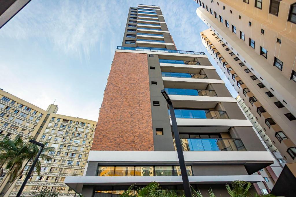 a tall building with a tall brick tower at My Place in Curitiba