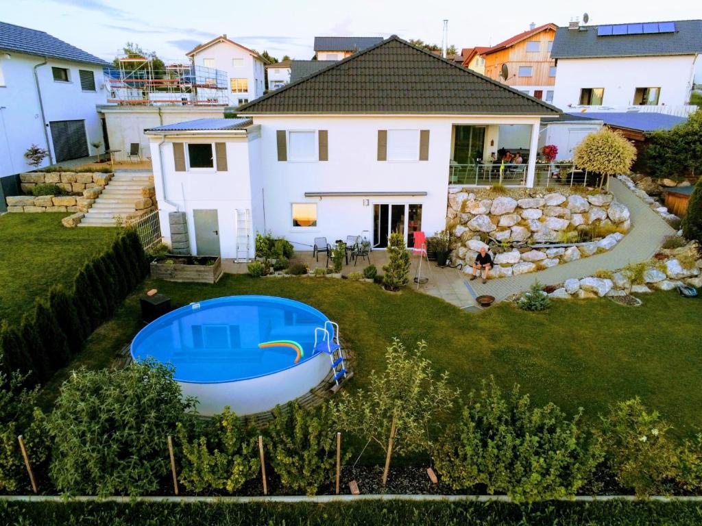 an aerial view of a house with a boat in the yard at Wohnung Mit Großer Gartenterrasse Und Ausblick in Argenbühl