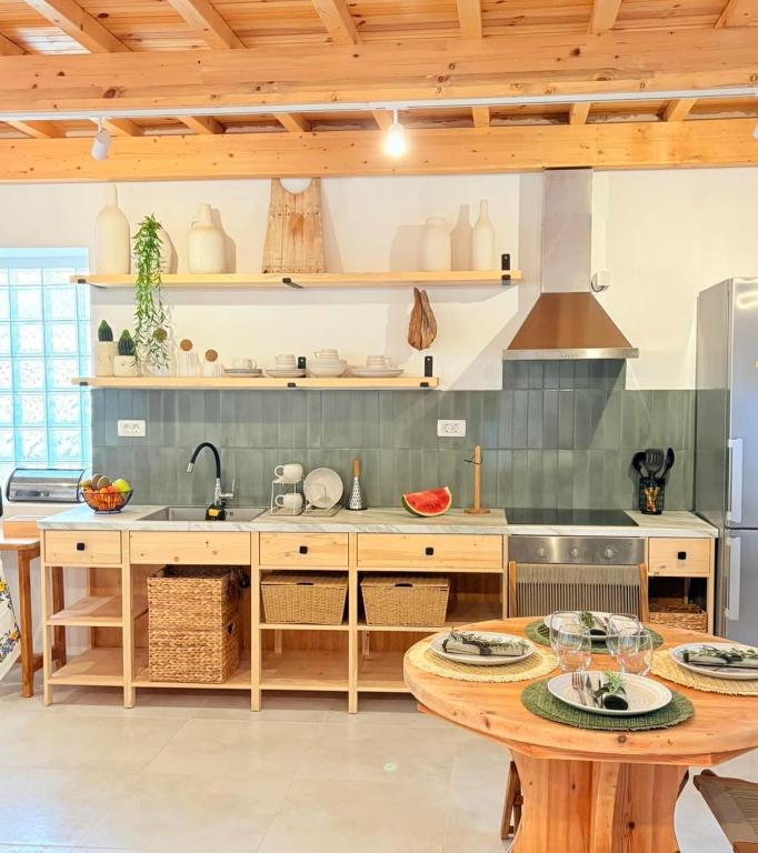 a kitchen with a table and a sink at Athina's Cozy Guest House in Kamisianá