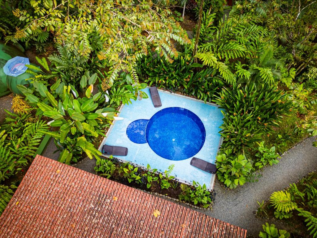 a painting of a blue object in a garden at Nowhere in Bocas del Toro