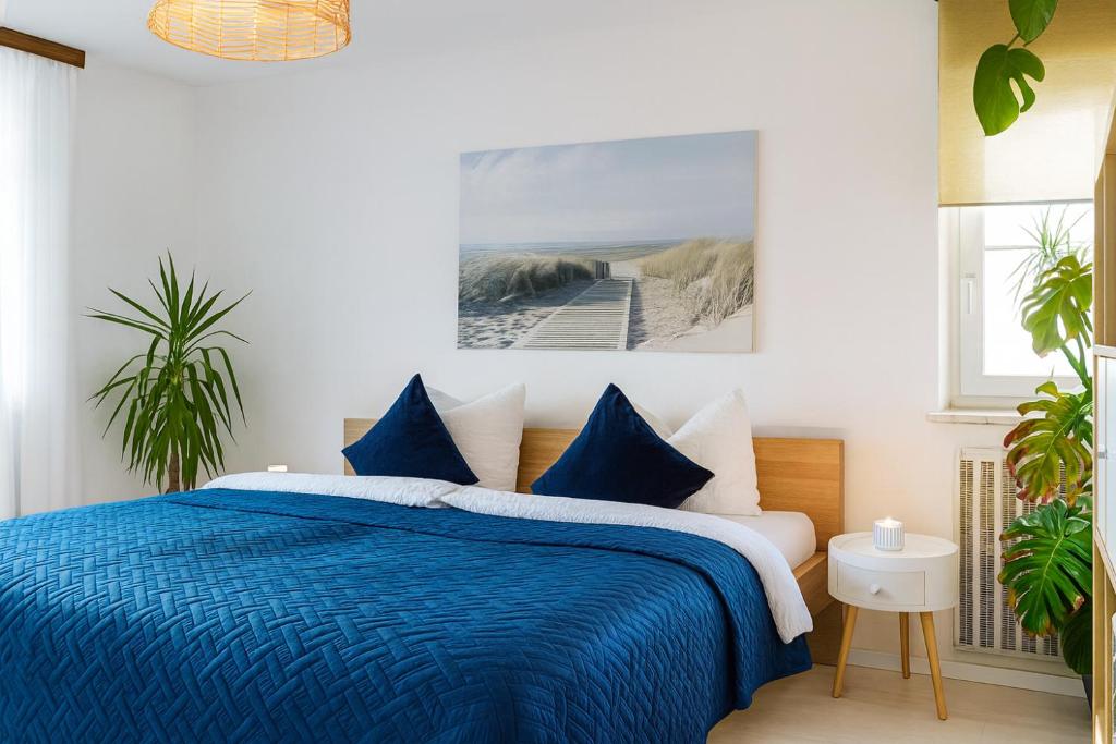 ein Schlafzimmer mit einem blau-weißen Bett und einem Steg in der Unterkunft Wintergarten Wohnung mit Feldblick in Jettingen-Scheppach