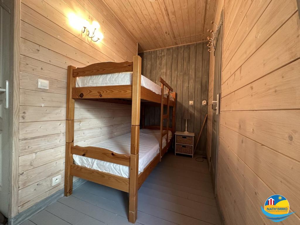 a bedroom with two bunk beds in a cabin at Sea View in Quend-Plage