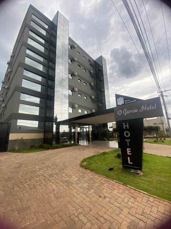a large building with a sign in front of it at D` Garcia Hotel in Três Lagoas