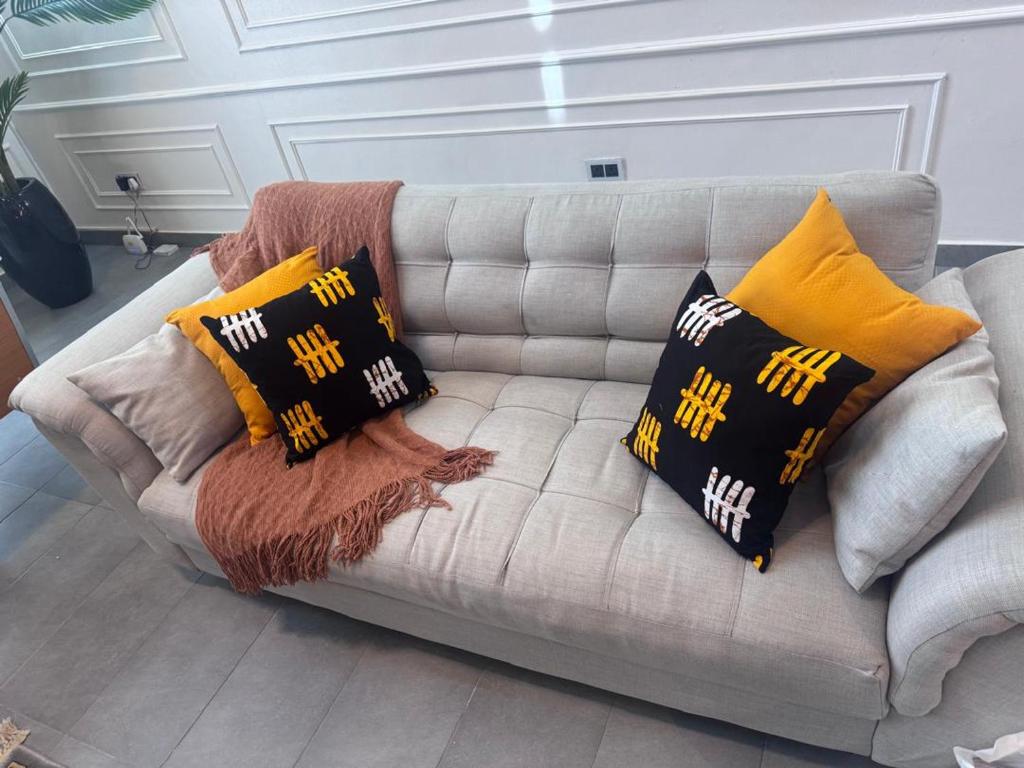 a couch with pillows on it in a living room at Emerald harbor apartments in Lekki