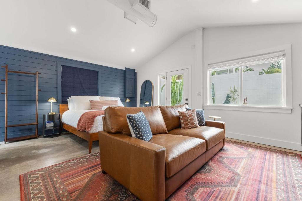 a living room with a couch and a bed at La Casita - Steps from 7th Ave in Tampa