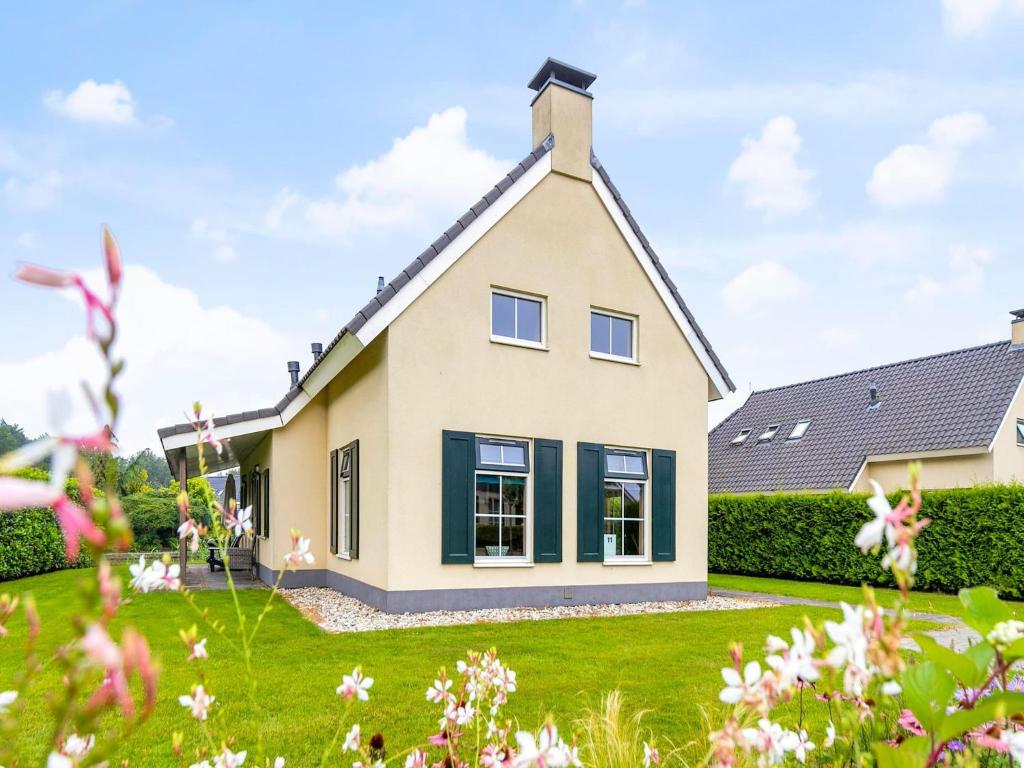 a house with a green lawn at Detached house in Vlagtwedde with sauna in Vlagtwedde