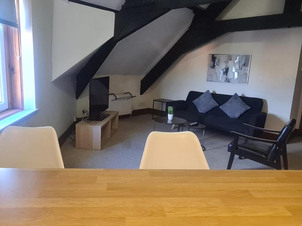 a living room with a couch and a table and chairs at 2 bed central apartments in South Shields