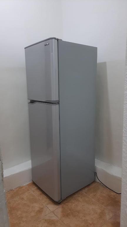 a white refrigerator in a corner of a room at Stone house in Amman