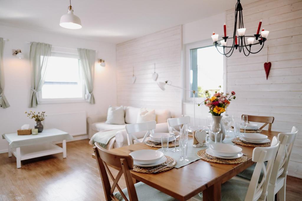 a dining room with a table and a couch at Srdeční záležitost Boží Dar in Boží Dar