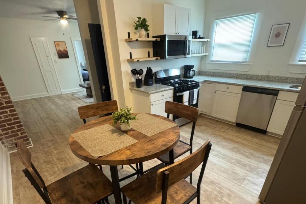 a kitchen with a wooden table and chairs in a kitchen at Fully Furnished Monthly Stay or Weekend Getaway in Hot Springs