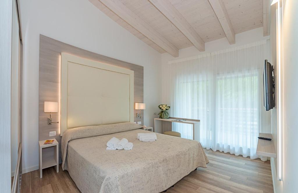 Postel nebo postele na pokoji v ubytování Park Hotel Pineta & Dependance Suite