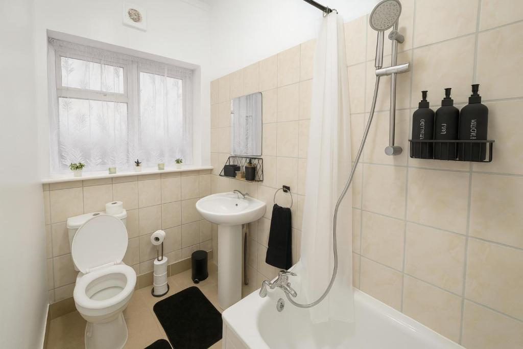 a bathroom with a shower and a toilet and a sink at Modern 4 bedroom house in Belvedere in Erith