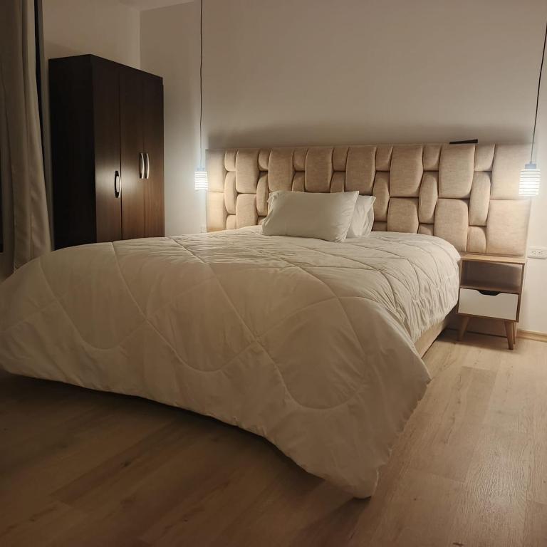 a bedroom with a large bed with a large headboard at El descanso in Papallacta