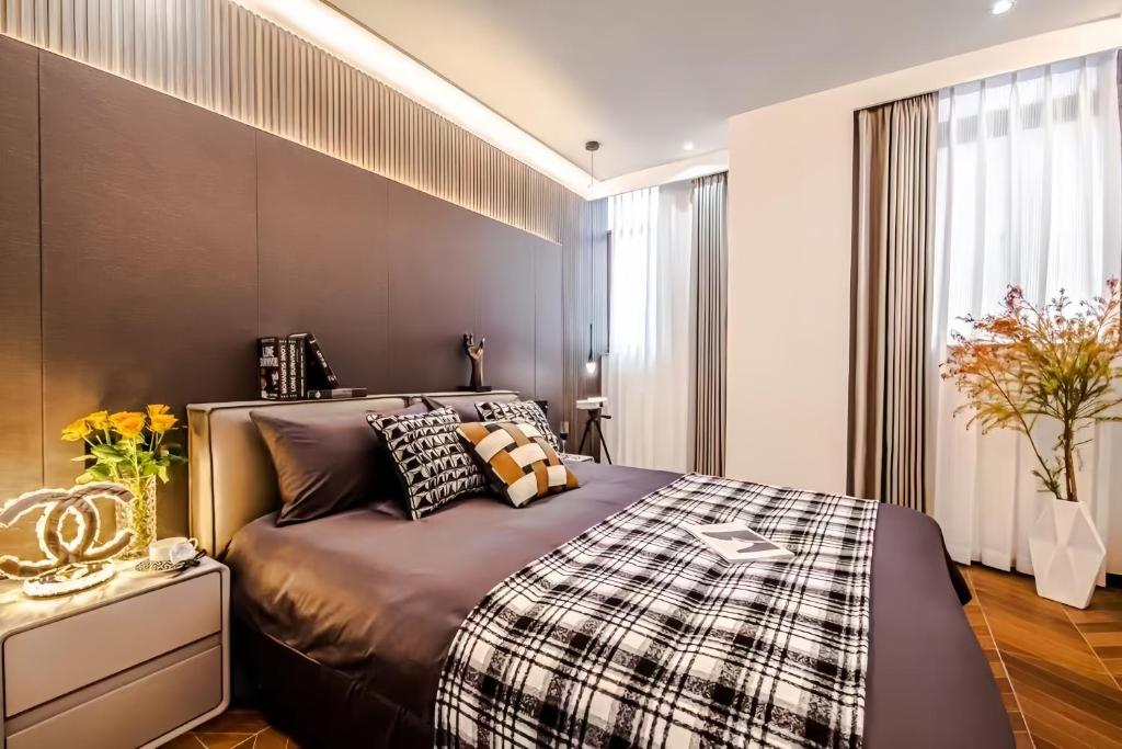 a bedroom with a large bed and a window at Shanghai Hills&Rais Apartment - 100-inch Projector - Near Nanjing Road Pedestrian Street in Shanghai