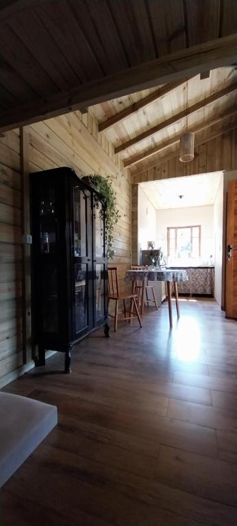 a dining room with a table and chairs in a barn at Chalé da Montanha in São Roque