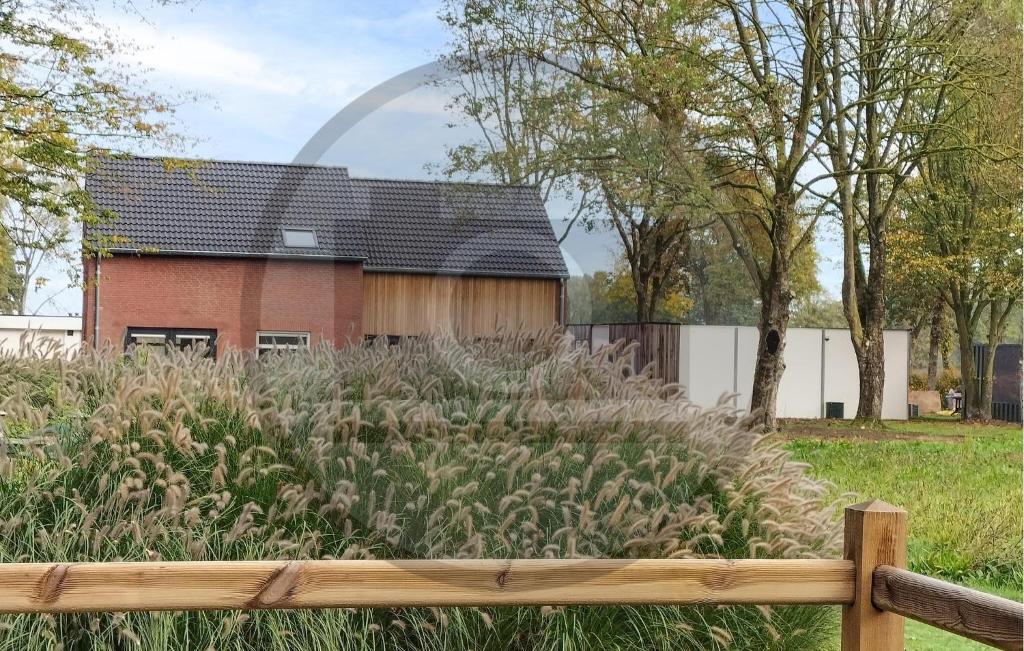 a garden with a house in the background at Stunning Home In Afferden in Afferden