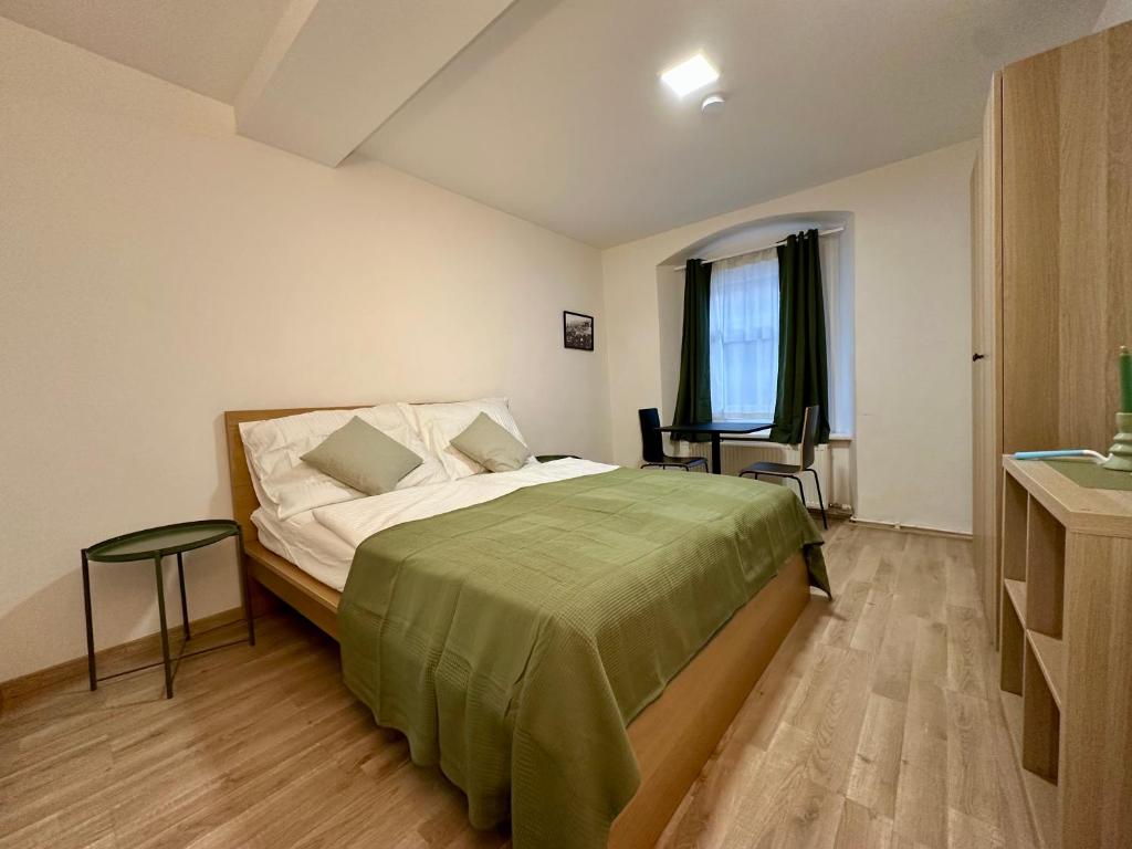 a bedroom with a bed and a table and a window at RP-Apartments in Graz