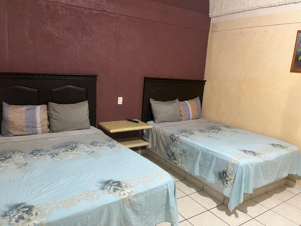 En eller flere senge i et værelse på Hotel Diana cazadora