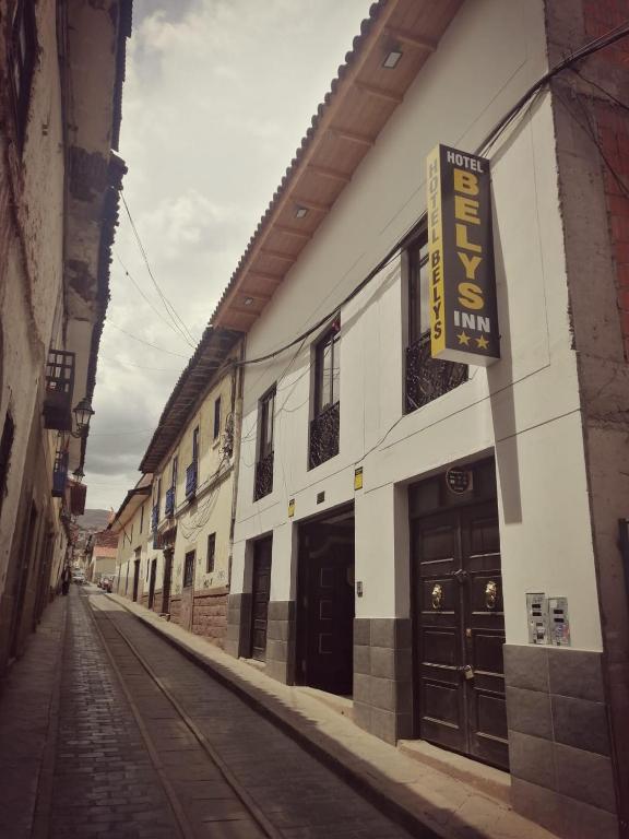 a building with a sign on the side of a street at Belys inn in Cusco