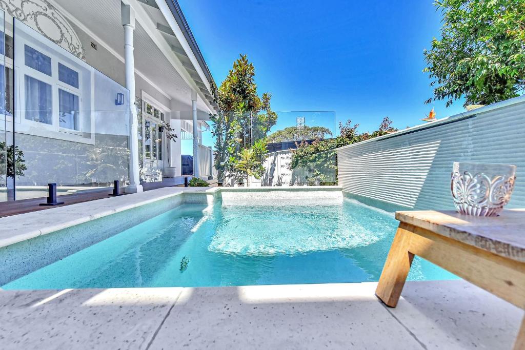 a swimming pool in the backyard of a house at Merewether House 1910 - Iconic and Luxury Home in Merewether
