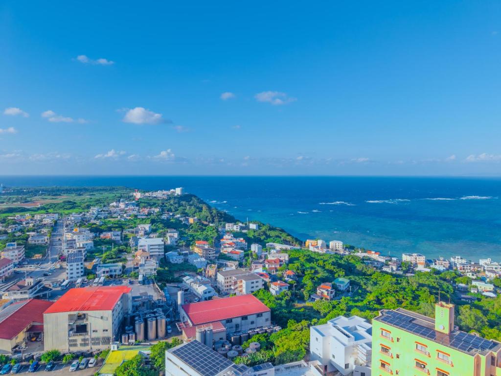 an aerial view of a city and the ocean at 読谷Nagahama270度4LDK オーシャンビュー最上階民宿 in Yomitan