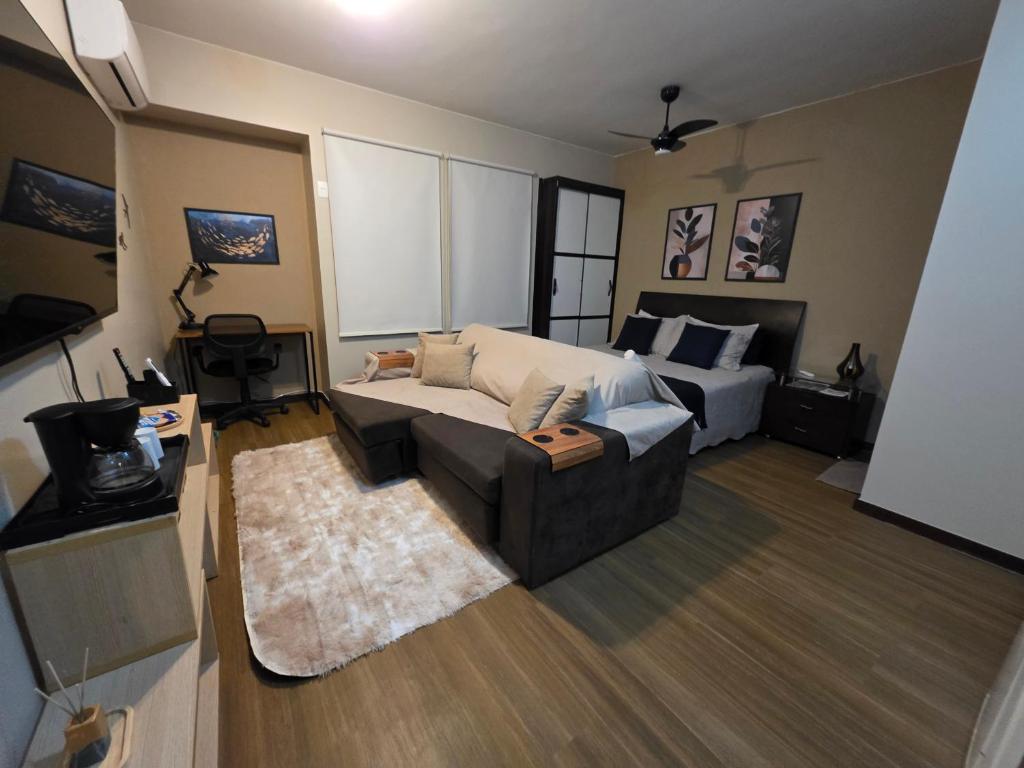 a living room with a couch and a bed at Studio no Sudoeste in Brasilia
