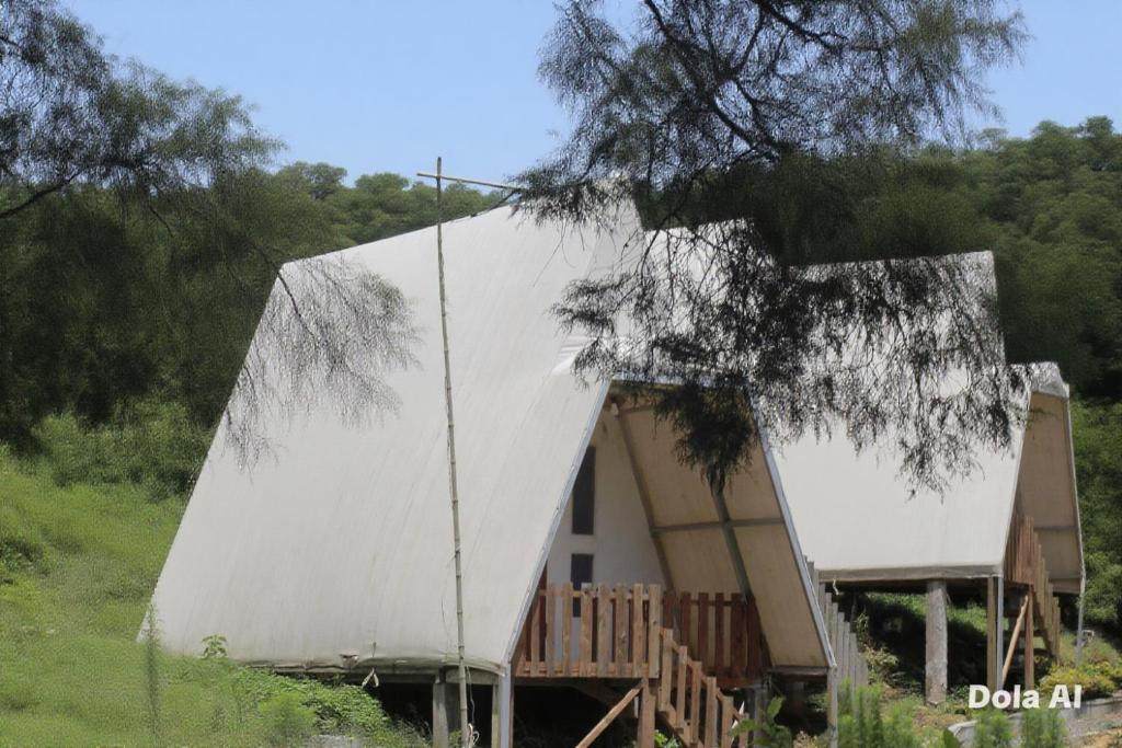 a house with a white cover on the side of it at Dieng glamping syari'ah in Dieng