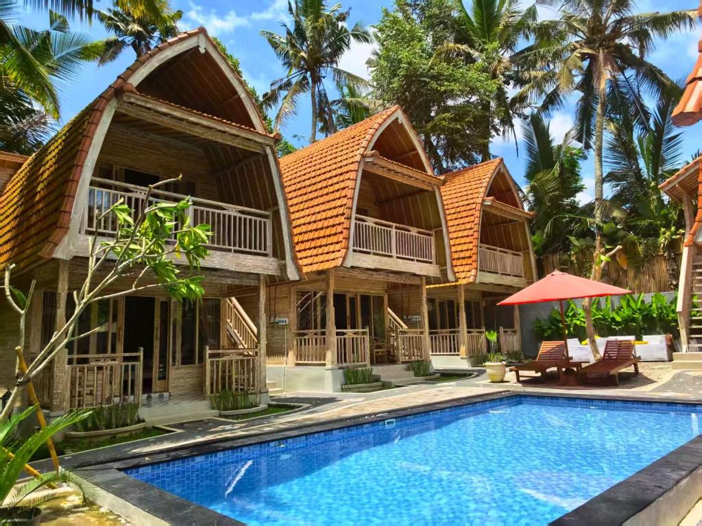 a villa with a swimming pool and a resort at Brady's Ubud Villas in Ubud