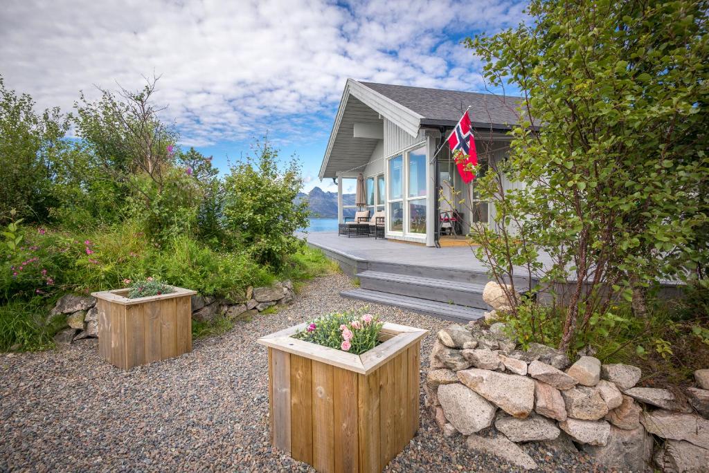 a house with two flower pots in front of it at Vestfjord Panorama Villa in Nes