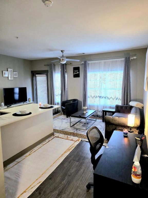a living room with a couch and a table at Skyline Serenity- Gym, Walk to Bars and Restaurants in Charlotte