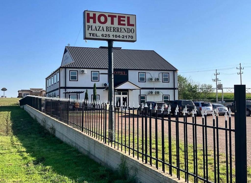 a hotel behind a fence in front of a building at Hotel Plaza Berrendo in Campo Menohita 307
