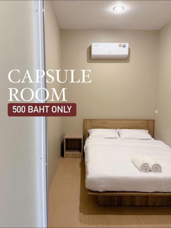 a bed in a room with a sign that reads capsule room bath only at Easy Hotel - 1 min Train Station in Hat Yai