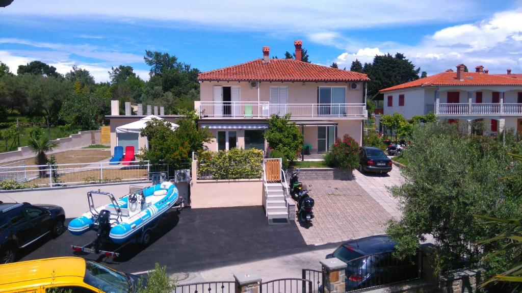 a house with a boat in a parking lot at Apartments Pronavtik in Piran