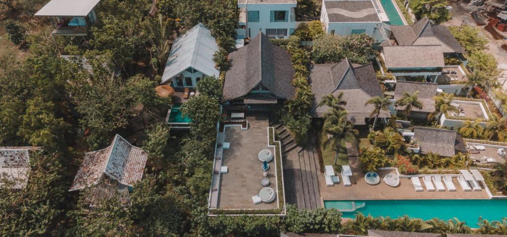 an aerial view of a house with a swimming pool at Light The Path Bali in Uluwatu