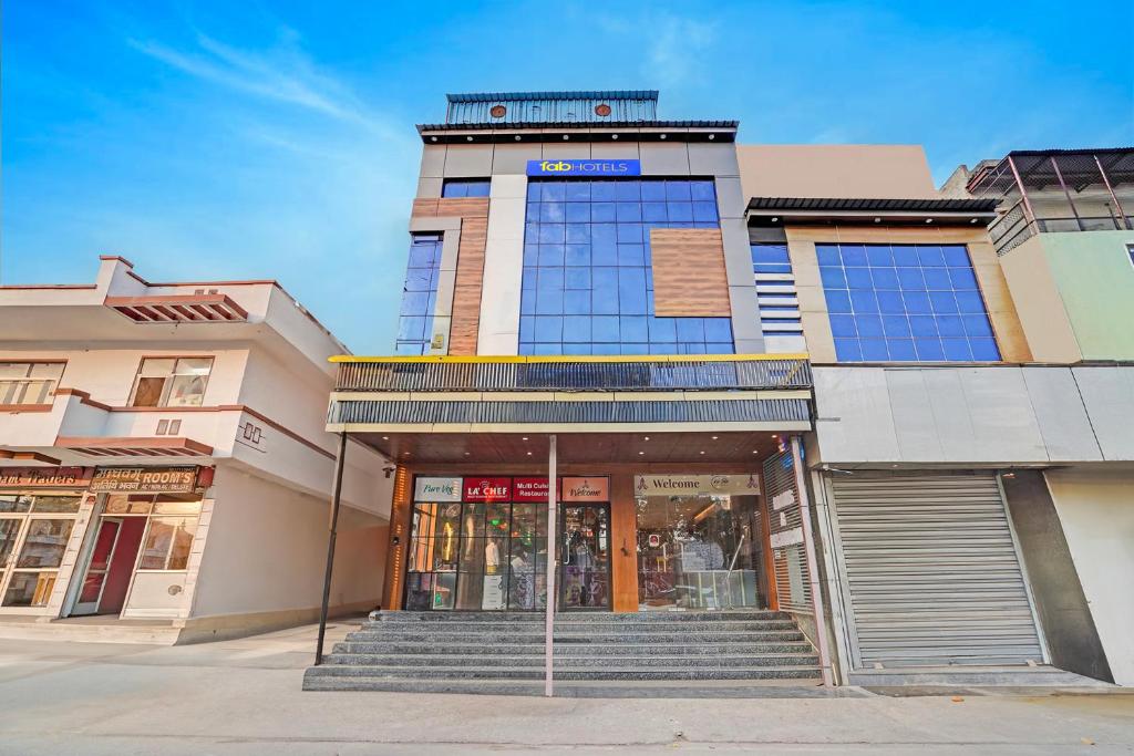 a building with stairs in front of a store at Hotel Rohan Palace in Vrindāvan