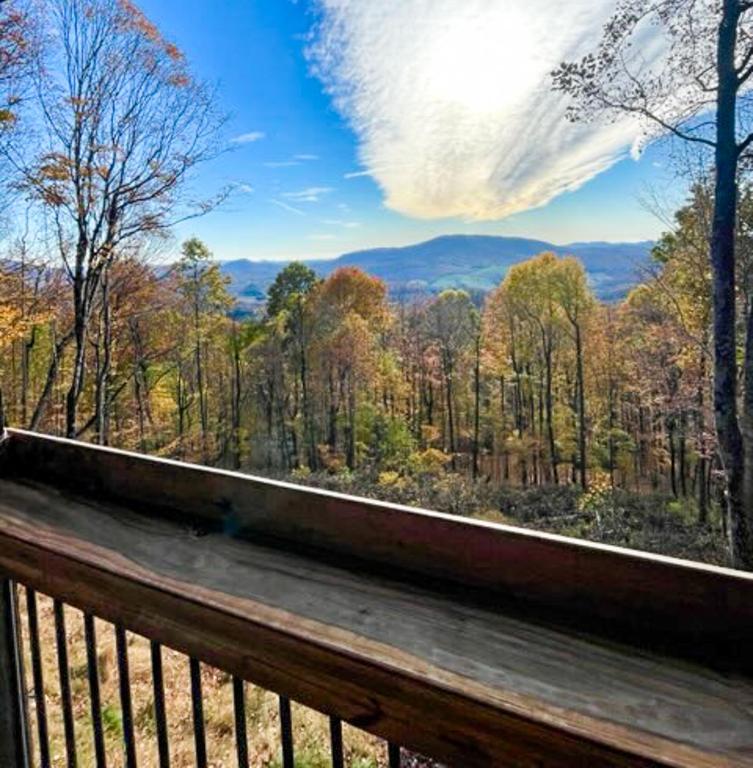 a view of a forest from a wooden deck at El Cabitan in West Jefferson