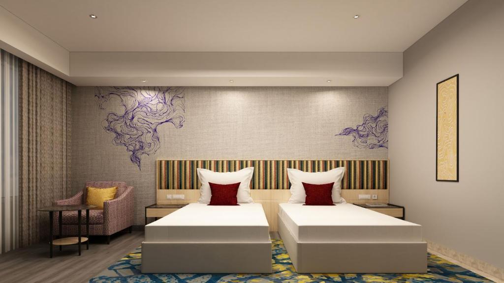 Ένα ή περισσότερα κρεβάτια σε δωμάτιο στο Vivanta Kochi, Aluva