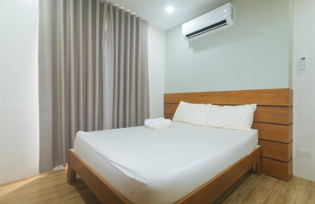 Ένα ή περισσότερα κρεβάτια σε δωμάτιο στο Avelida Homes by RedDoorz