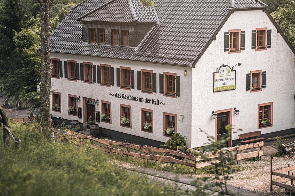 ein weißes Gebäude mit einem schwarzen Dach in der Unterkunft Grosses Ferienhaus für bis zu 22 Personen luxuriös ausgestattet mit Aussensauna und HotTub in Dahlem