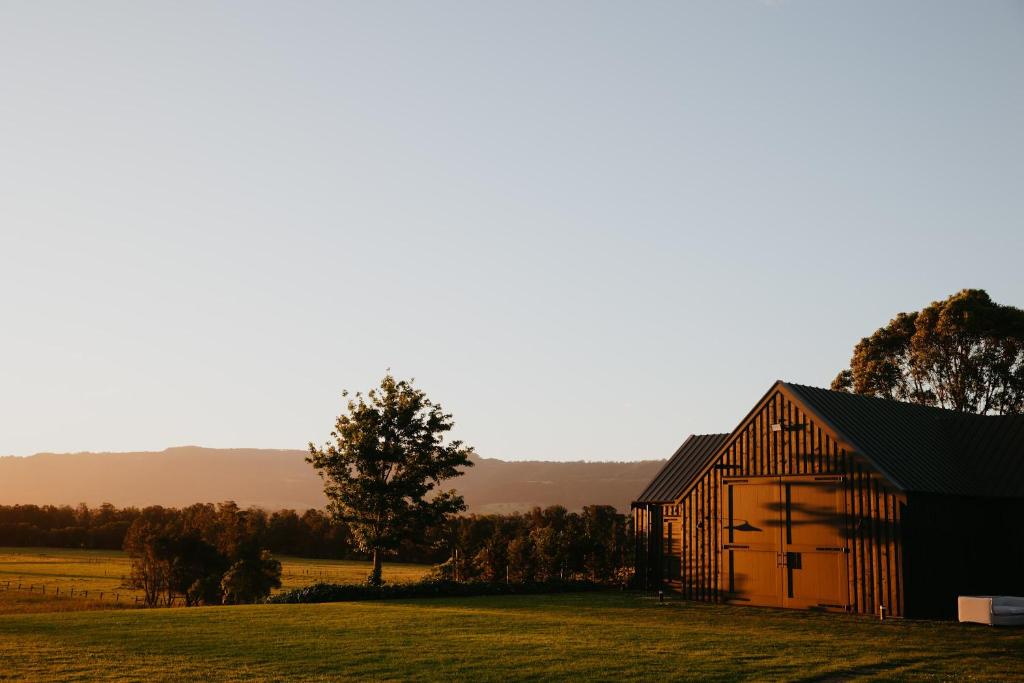a barn in the middle of a field at Linnaeus Farm, Berry - by Linnaeus Collection in Berry