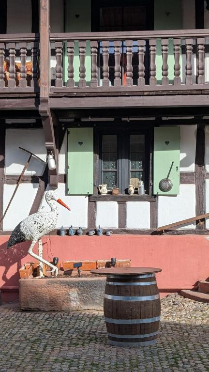 a statue of a bird standing in front of a building at Les Perles du Ried - Gîte 8 - 15mn Europapark - proche Strasbourg Colmar in Boofzheim